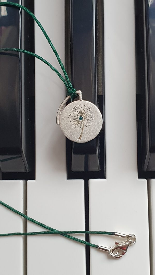 Runder Silberanhänger handgravierte Pusteblume mit Diamant auf dem Klavier